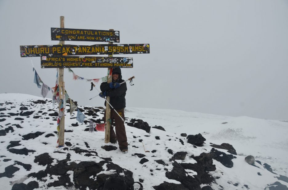 A male standing on a snowy mountain top